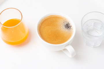 coffee, orange juice and water for breakfast close-up
