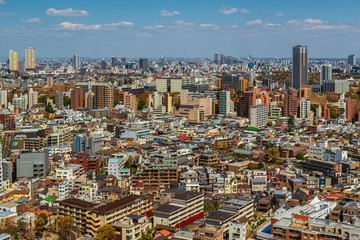 Tokyo endless suburbs, a wall of concrete buildings view from above