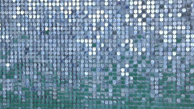 Background from sparkly sparkles sparkling in the wind. Sparkling glitter background, sequins texture bokeh with iridescent luster