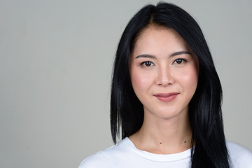 Obraz premium Face of young beautiful Asian woman looking at camera