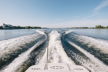 Trace tail of speed boat on water surface in the sea- natural and vacation background