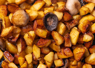 Fried potatoes with mushrooms background