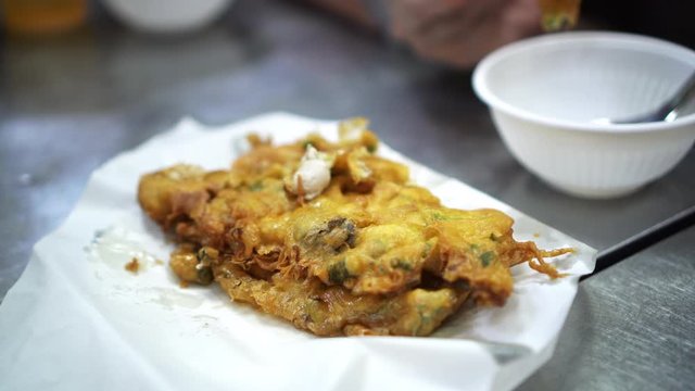 Chopsticks sharing crispy Chinese oyster fried pancake