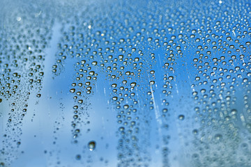 water drop on glass window raining background blue texture nature
