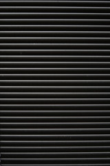  Thin lines of light on the wall. Shadow from the blinds. bathroom.