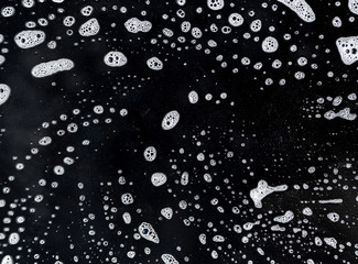 Abstract foam texture on black background. Soap foam bubbles abstract dark background , top view