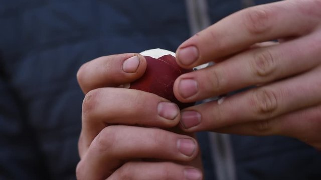 
man brushes boiled egg with his hands