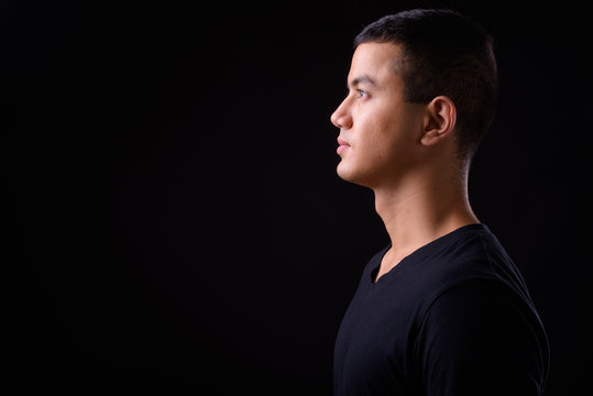 Profile view of young handsome Asian man
