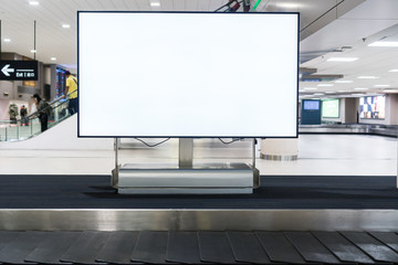 Blank advertising billboard at conveyor belt luggage in airportat airport. Copy space for cutomer...
