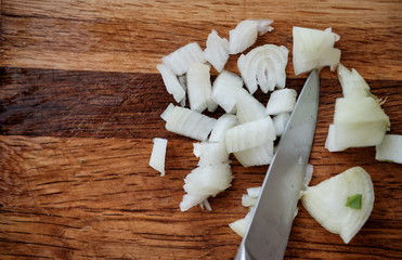 chopped onion on a board. knife with a bow. healthy food. chopped onion