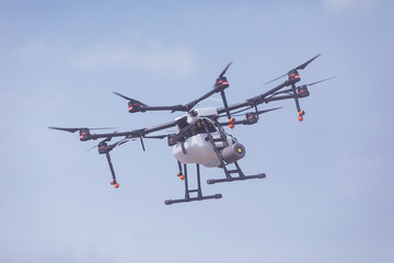 Fototapeta na wymiar professional industrial drone in flight eight test propellers