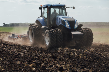 big blue tractor with big wheels in a field in summer at an agricultural exhibition © dobrovizcki