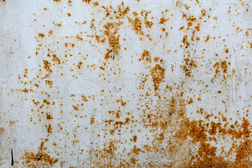 Metal surface with white paint that has passed temporary damage, a lot of formed, red rust. Textured background with traces of destruction and deformation