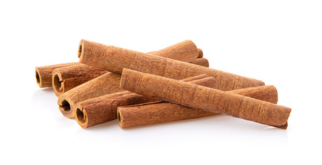 cinnamon sticks stacked on white background