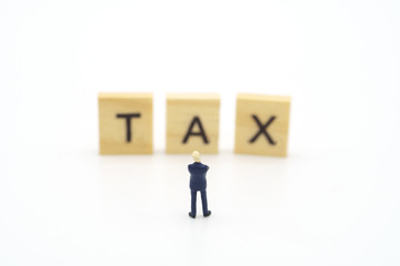 Miniature people Pay queue Annual income (TAX) for the year on calculator. using as background business concept and finance concept with copy space  for your text or  design.