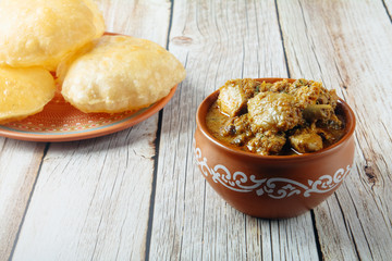 South Indian traditional food Poori or puri with country chicken curry	
