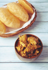 South Indian traditional food Poori or puri with country chicken curry	
