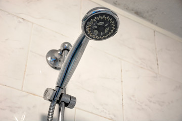 Dirty chrome shower head with limescale that should be cleaned and mold on tiles and ceiling....