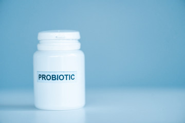 white bottle with probiotic lettering on blue with copy space