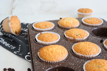 Homemade muffins in bakeware, selective focus