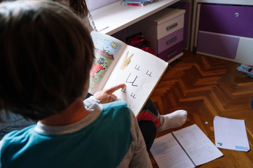 Boy learning to read at home