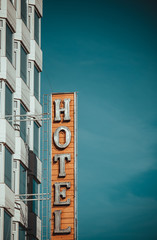 Modern hotel building and sign with blue sky behind.