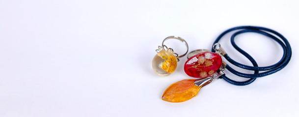 pendant and rings with dried flowers inside crystals made of epoxy resin