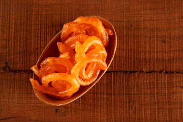Indian Sweet Jalebi in a handmade pottery bowl on wooden background