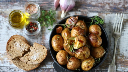 Baked potatoes in their skins on a rustic style. Cooking at home.