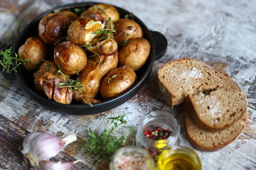 Baked potatoes in their skins on a rustic style. Cooking at home.