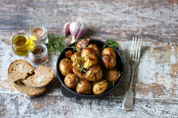 Baked potatoes in their skins on a rustic style. Cooking at home.
