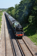 steam locomotive 60163 Tornado on a mainline excursion train near Wareham in England, UK