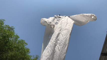 Protective PPE suit hanging outdoor after the used and washing,natural glare light,the ppe suit can to repeated use 2-3 times,after use every day should wash and dry in the sun,prevented covid-19.
