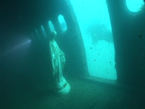 mothermary statue underwater in an airplane wreck  ocean scenery