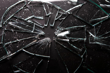 Broken glass with lots of  splinters on black background  for artistic backgrounds