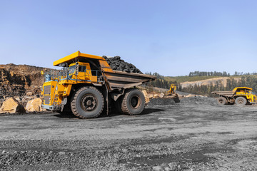 Big yellow mining truck for coal move. Open pit mine industry