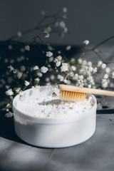 Natural bamboo toothbrushes and tooth powder on a grey background