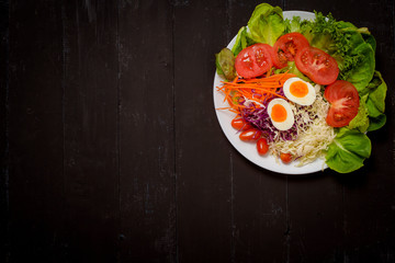 Vegetables Salad on black  wooden  background