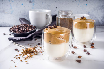 Trendy drink, dalgona coffee. Whipped instant coffee drink with cold milk and sugar. Fluffy creamy whipped coffee beverage, on white background, copy space