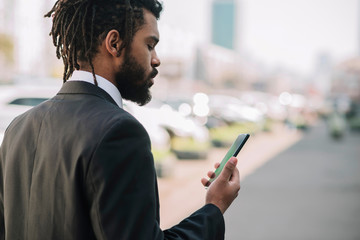 Afroamerican employee looking at phone
