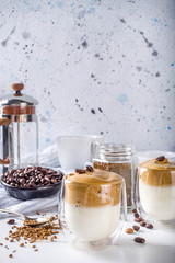 Trendy drink, dalgona coffee. Whipped instant coffee drink with cold milk and sugar. Fluffy creamy whipped coffee beverage, on white background, copy space