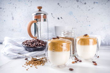 Trendy drink, dalgona coffee. Whipped instant coffee drink with cold milk and sugar. Fluffy creamy whipped coffee beverage, on white background, copy space