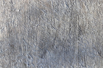 An old, smooth, gray uniform Board with vertical stripes and a lot of long cross hairs.