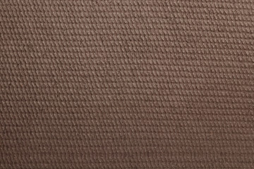 The reverse side of the old linoleum sheet has a fluted brown surface in the form of horizontal stripes.