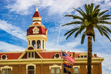 Building With Clock Tower Displaying American, Arizona & POW Flags