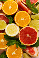 Obraz na płótnie Canvas Orange, lemon, grapefruit, mandarin and lime on trendy pink stone or concrete table background. Citrus fruits. Top view, flat lay