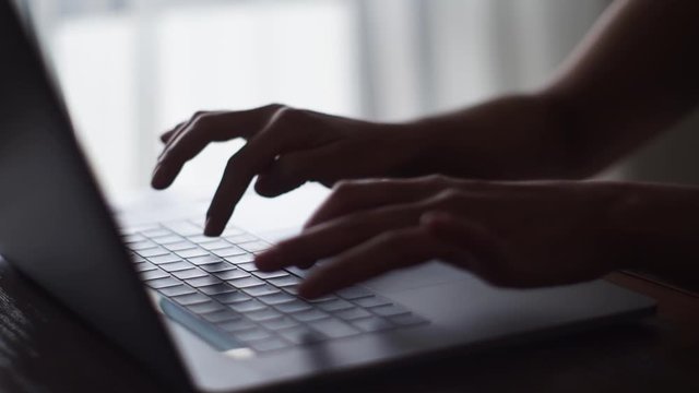 Typing on a laptop computer