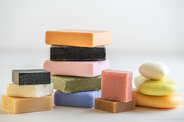 selection of colorful  natural rose olive orange carbon coal charcoal black soap bar block isolated on white background 