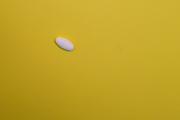 Medicine pill, on yellow background