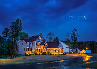 Powerful lightning storm front passes over residential houses - 341347981